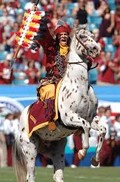 Chief Osceola and Renegade storming the field before a game.