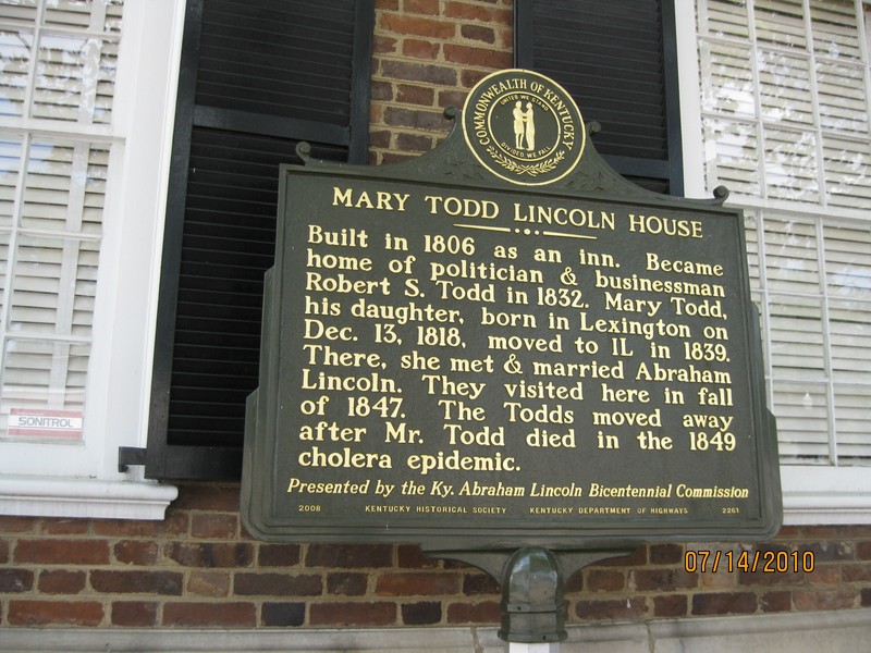 A plaque outside the house provides information about the house.