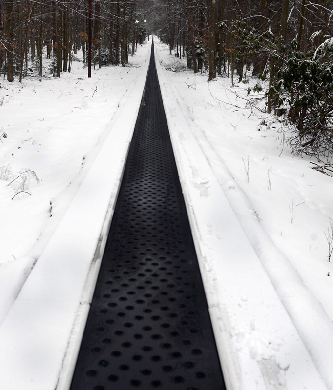 This is some of the 1400 foot long conveyor used to bring people back up the mountain after they sled down. It is possibly the longest conveyor in America today.