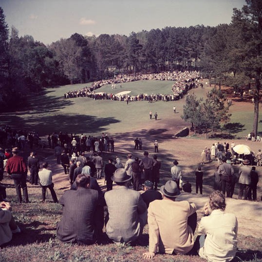 "Patrons watch Tournament play on the 6th green." (1961) Photo courtesy of http://www.masters.com/en_US/discover/timeline.html. 