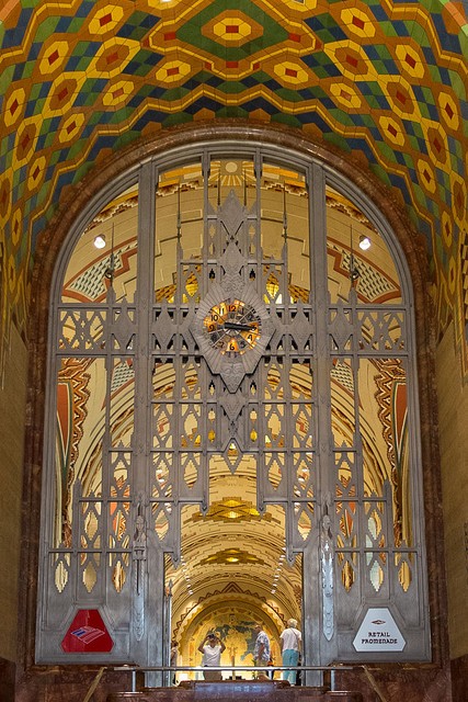 Tiffany clock in metal framework separating the lobby from the promenade. "Guardian Building Detroit Interior Clock" by Vincent Arel. Licensed under CC BY-SA 3.0 via Wikimedia Commons