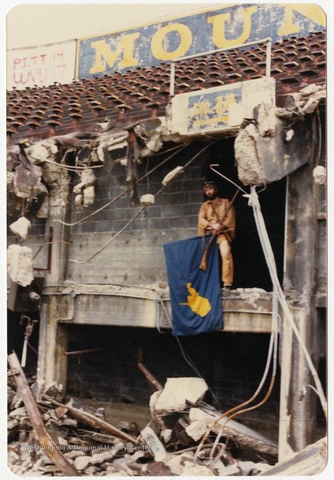 Official Mountaineer mascot Matthew Zervos laments the loss of the original Mountaineer Field in the mid-1980s as the demolition is in progress. West Virginia & Regional History Center.