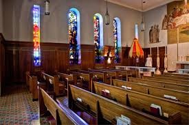 The side chapel features several stained-glass windows.