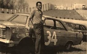 Wendell Scott standing in front of his race car.