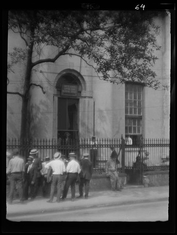 Men standing in front of the bank sometime between 1920 and 1926.