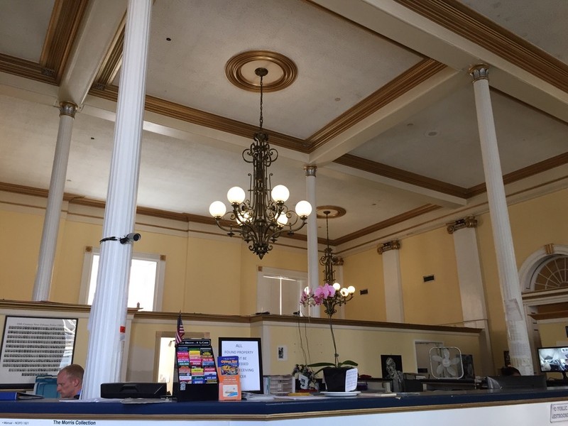 The soaring ceilings are readily apparent in this photo of the interior of the old bank building, as is the police officer of the French Quarter's 8th District.  