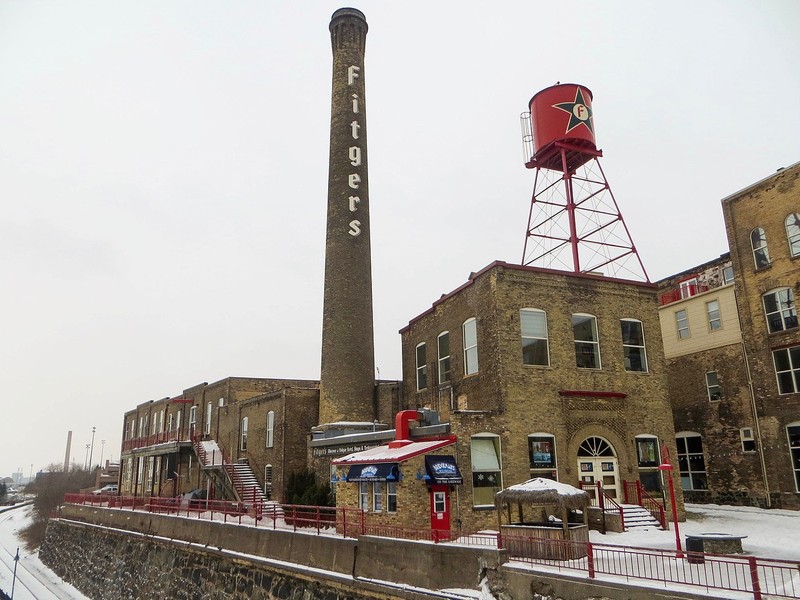 The former Fitger's Brewing Company complex, in Duluth, Minnesota, viewed from the northeast, in January 2016. According to the historic uses, the nearest building (with water tower atop it) was the Ice Machine building, to its left (with smokestack attached) was the Boiler House, and farthest back the Wash & Racking House.