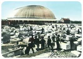 Color-rendered photo of temple workers preparing granite for temple construction. Famous Tabernacle sits in the background. This photo was likely taken in the 1860s.