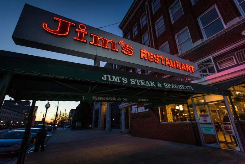 Jim's sign lit up at night