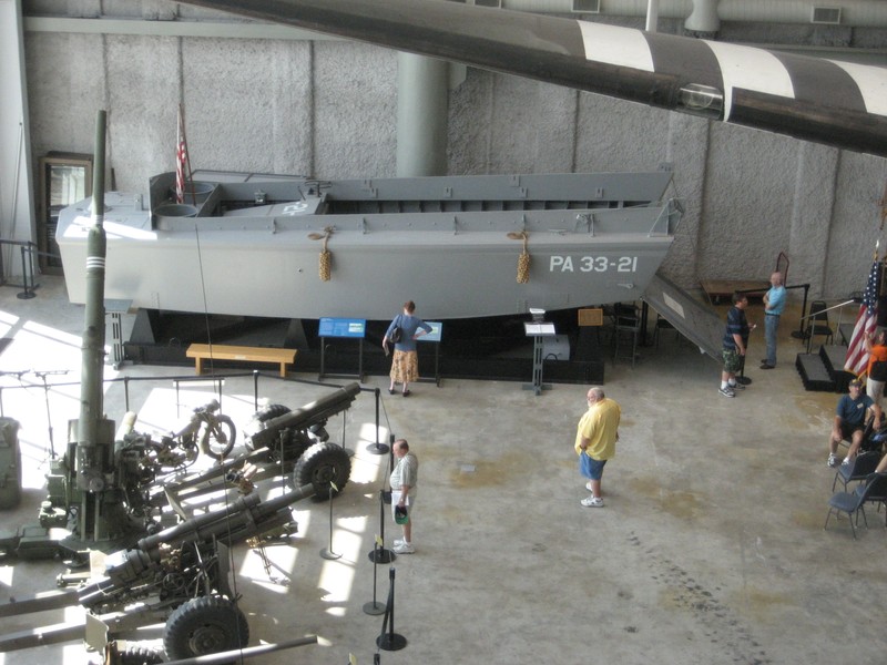 A Higgins Boat and various pieces of artillery on display.