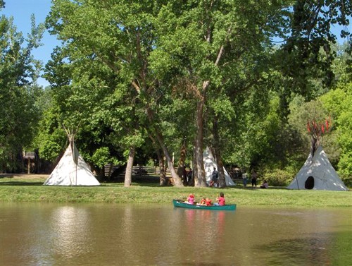 View of the canoe pond that is bordered by recreated tepees. 