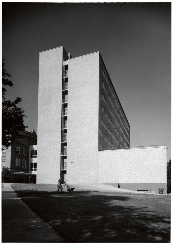 Black and white photograph showing the tall, modernist brick exterior of the Medical Research Building on the Marquam Hill campus of the University of Oregon Medical School.