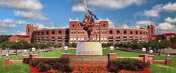 The Unconquered Statue with Doak S. Campbell Stadium as the backdrop.