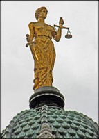 On top of the copper shingles of the cupola is a bronze statue of Justice. The statue was part of the building's original plan but was not par of the building until renovations in 1988.