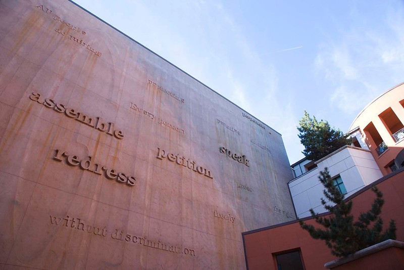 Words drawn from the state constitution are incorporated into the museum's courtyard wall. The wall and its words change with the elements and sunlight to reflect the living nature of the constitution. 
