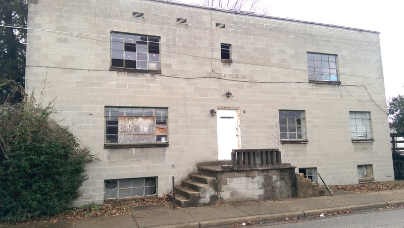 This is the front view of the Hopson building in which the top floors were apartments and the lower portion of the building was where the medical practice was located . 