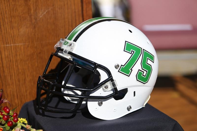 One of many traditions, the Marshall football team wear helmets and play in honor of the 75 at the home game preceding November 14th each year. 