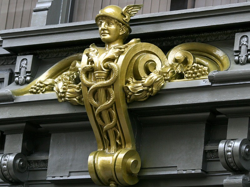 Above the entrance: Mercury, the Winged Messenger.