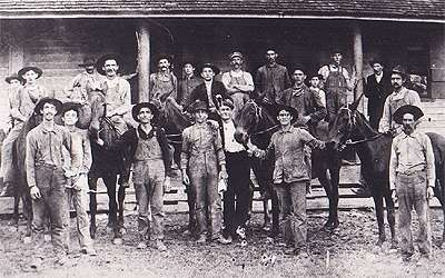 1905: Two millers, customers and mules, on the front porch of the mill, at the turn of the 20th century 
                        1905 photo by James B. Finley