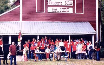 1999: Three millers, Prater's Mill Gang volunteers with mule, on the front porch of the mill, at the turn of the 21st century.
                        1999 photo by by Amy Holcomb