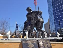 Picture of Mario Lemieux Statue as he busts through two defensive players to drive for a goal. 
Picture courtesy of:  news.gonzaga.edu