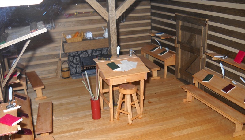 One of several shelves of classroom materials on display at the museum.