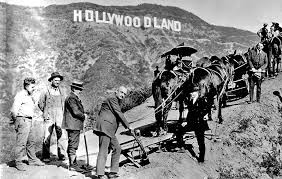 Men trudging up the outrageously steep Mount Lee to visit the real estate billboard