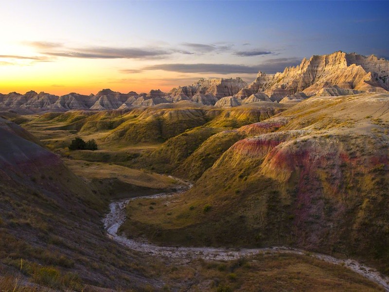 This picture shows the ridges in the mountain sides. These were made by sediment that was laid down and then taken away by the wind or water passing through the rocks.