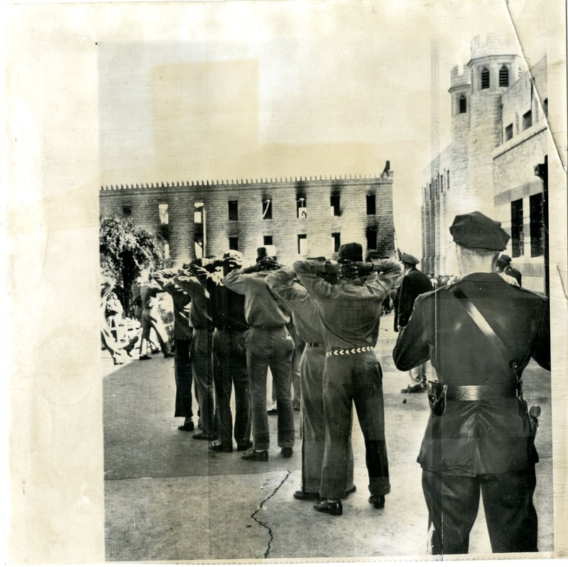 Inmates & Missouri Highway Patrol officers after the bloody riot at MSP in 1954. Notice the burned out building in the background. Image courtesy Mo. State Museum.