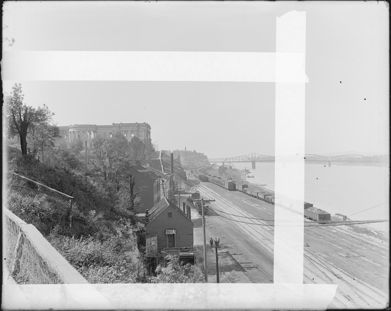 Glass plate negative taken in 1911 looking west toward the ruins of the old Mo. State Capitol.  Also shows the buildings which now constitute Jefferson Landing State Historic Site, in the foreground. Courtesy Missouri State Museum.