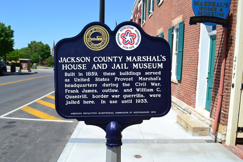 Closeup of the historical marker in front of the building.