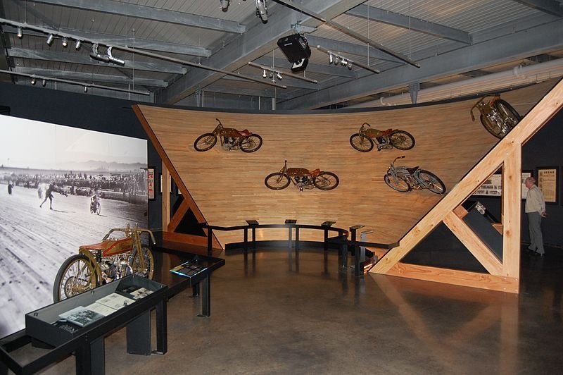 This exhibit of motorcycles racing along a banked wooden track is located in the museum's Clubs and Competition gallery.