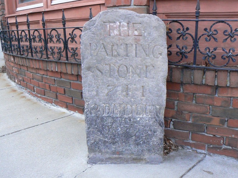 The "Parting Ways" Stone (erected 1741), part of the 1767 Milestones in Massachusetts. The stone is located in the Roxbury section of Boston. Image by User:Magicpiano. Licensed under GFDL via Wikimedia Commons.