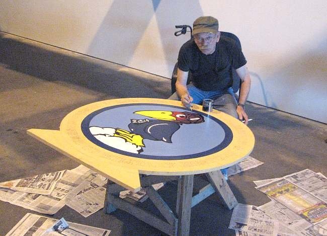 Jerry Blair, founder of the Kansas Museum of Military History, painting the museum's new logo. 