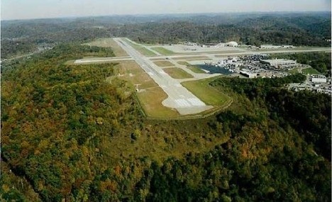 The landing strip at Yeager Airport formally Kanawha Airport. The grassy, forested hillside below the runway was the site crash and subsequent hunt for bails of marijuana.