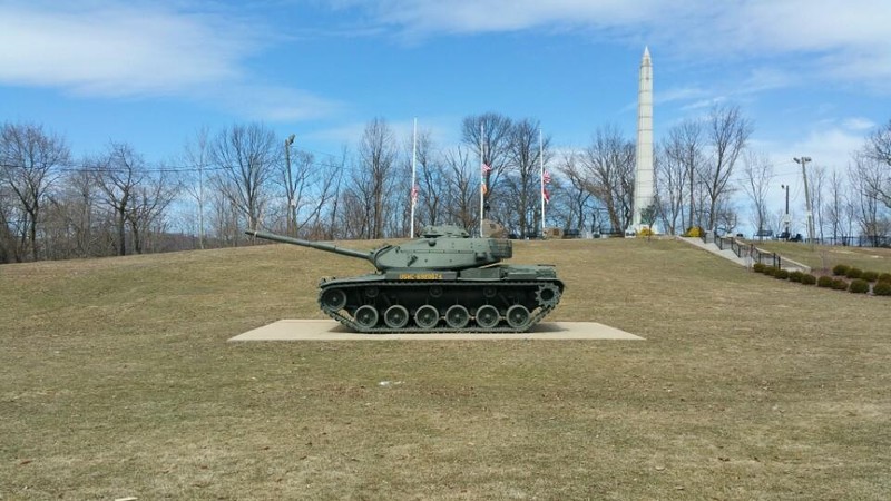 The memorial park includes several monuments and a static display of a tank. The memorial on the hill includes several plaques that honor veterans of multiple wars and conflicts.