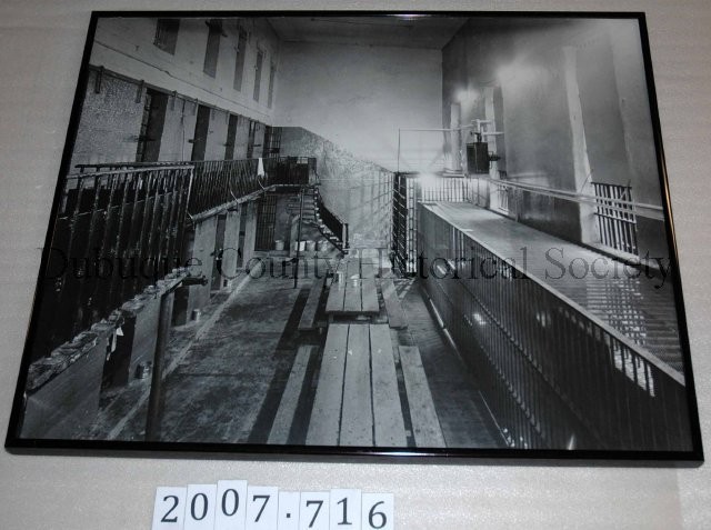 Print, Photographic, Black and white photograph featuring a view of the interior of the Old Dubuque County Jail. Courtesy of the National Mississippi River Museum.  Accession # 2007.716