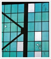 Windows in Hangar 79 with bullet holes from the attack