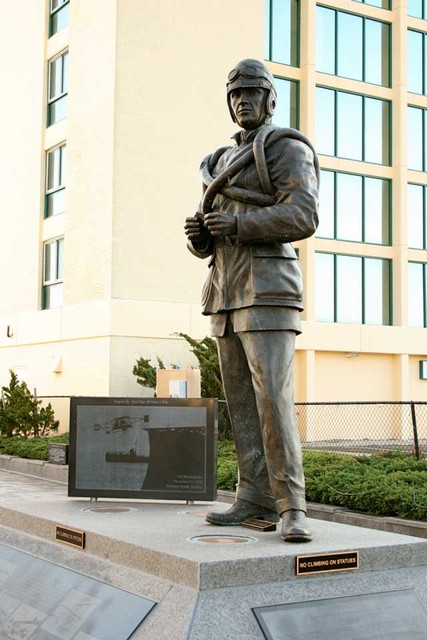 Bronze statue of Eugene Ely, the first pilot to fly a plane off of a ship deck.