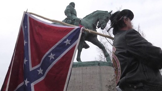 A counter-protester marches in defense of Confederate symbols during a March 2016 press conference discussing the fate of the Lee statue in Charlottesville. 