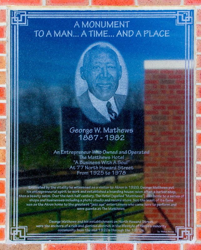 A modest plaque honoring the accomplishments of George W. Mathews, a business leader in the Howard Street district. 