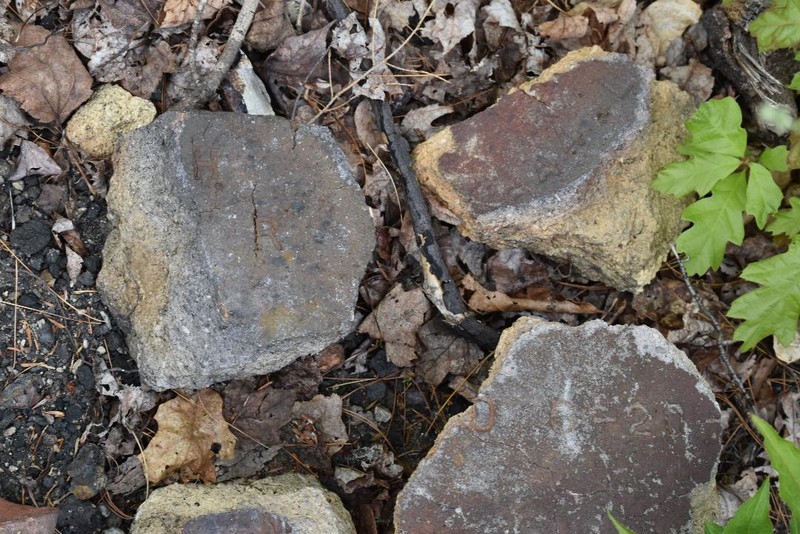 Rocks near the power lines with letter and numbers on them.