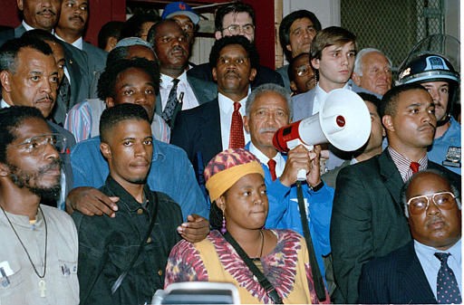 Then New York mayor David Dinkins (with megaphone) speaks to crowd at Gavin Cato's house.