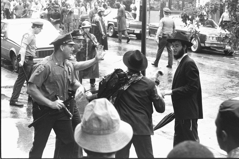 Police officers respond to a confrontation at Utica Ave. and President St. during the Crown Heights riots.