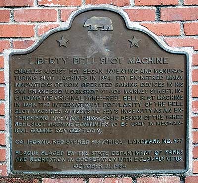 The marker is located on a small brick wall in the triangle formed by Market, Bush, and Battery Streets. 