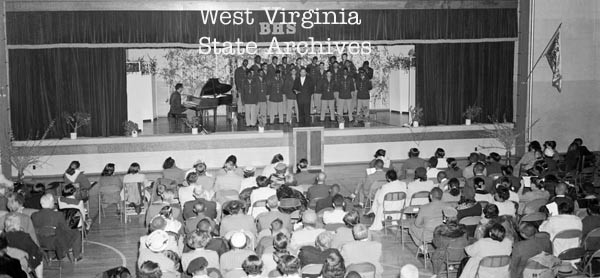 Undated Black and white photo of an all Black military chorus performing at auditorium at Bolling School.