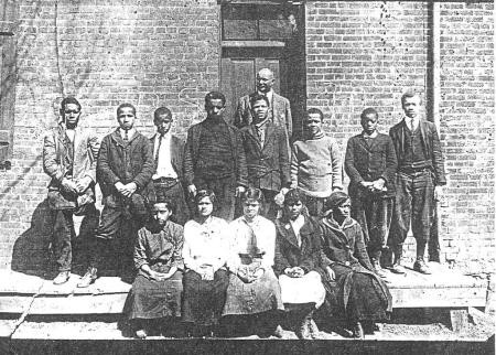 late 1800s photo of Philip Jackson (one of the namesakes of Page-Jackson HS) with his students at the Harewood school after leaving its original location in the Dixon home. 