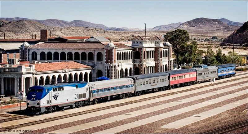 A view of the Harvey House depot and an Amtrak train next to it. Amtrak provides passenger rail service at the station.