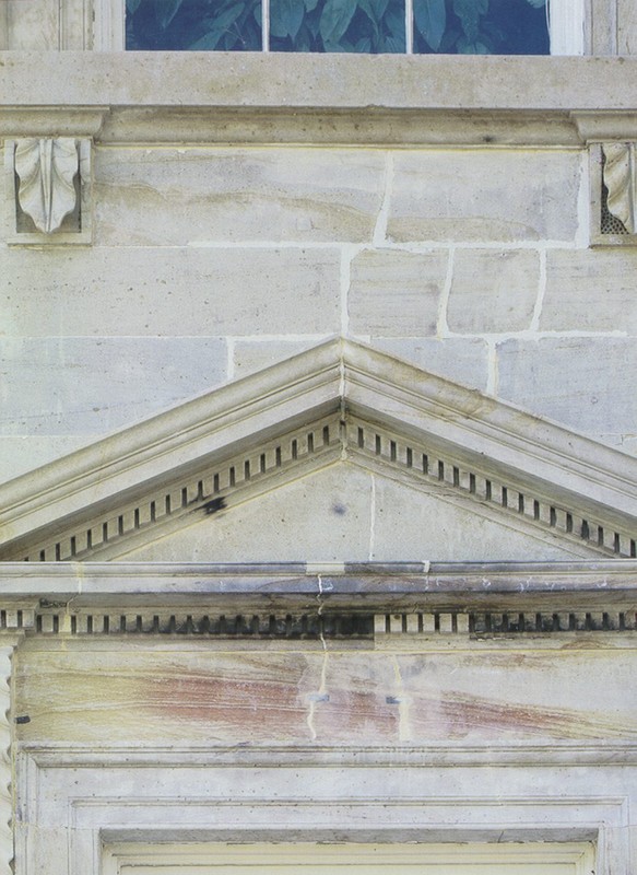 During building renovations in the 1990s, dozens of layers of paint were removed. This photograph of a section where the paint was removed shows the burn marks from 1814.