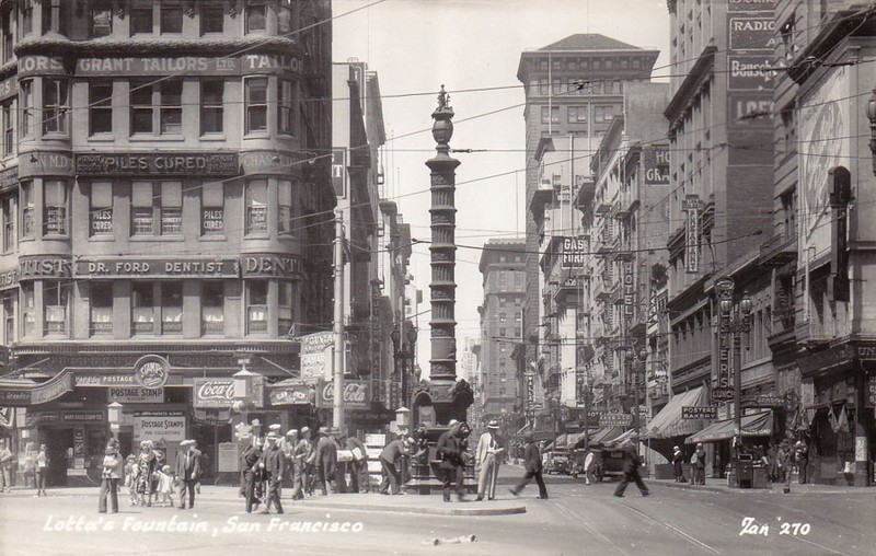 This 1930s image depicts the fountain with its larger column, which was added in 1916 to match the height of nearby streetlamps. It has since been reduced to its original height.